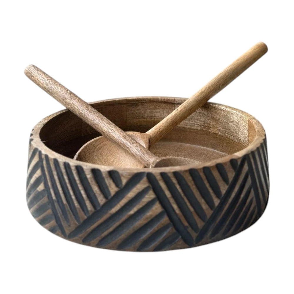 Wooden bowl with geometric pattern and two wooden spoons on a white background
