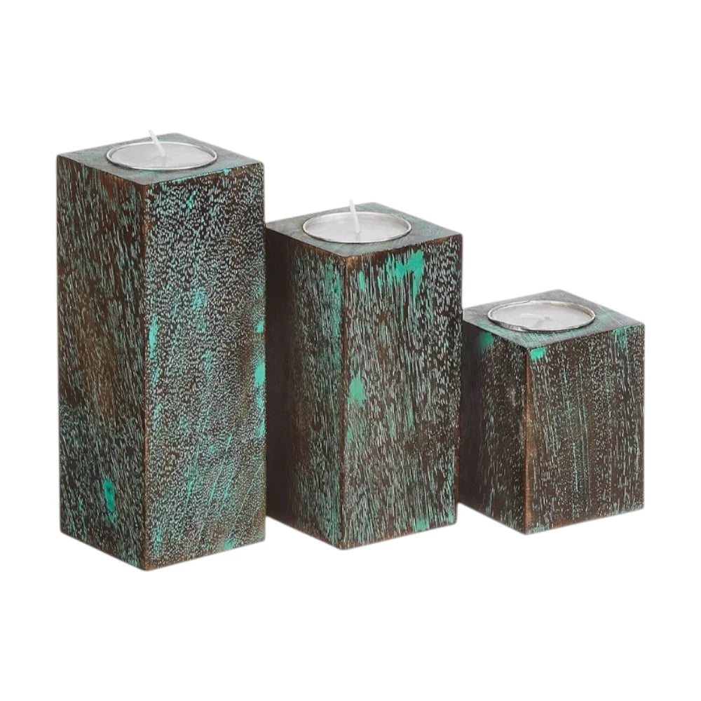 Three wooden candle holders with teal accents.